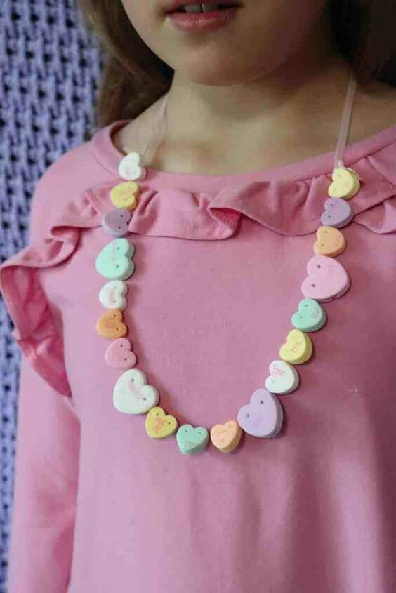 how to make a candy heart necklace, Candy Heart Necklace being worn by girl wearing a pink shirt