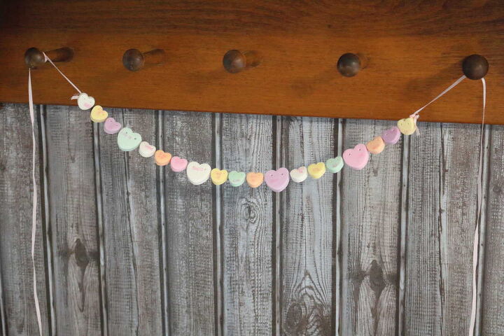 how to make a candy heart necklace, conversation heart garland tied to peg shelf for Valentine s day decor