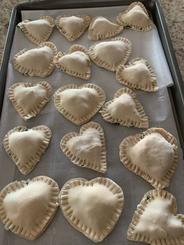 a savory valentine s day appetizer or a quick super bowl party appetiz, valentines day appetizer Here is a baking tray with hear shaped empanadas before they go into the oven