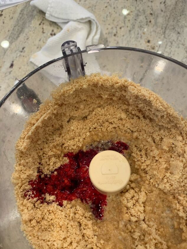 Cookie crumbs with red food dye added to the processor