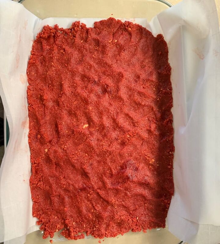 Smoothed out red dough in the prepared pan from above