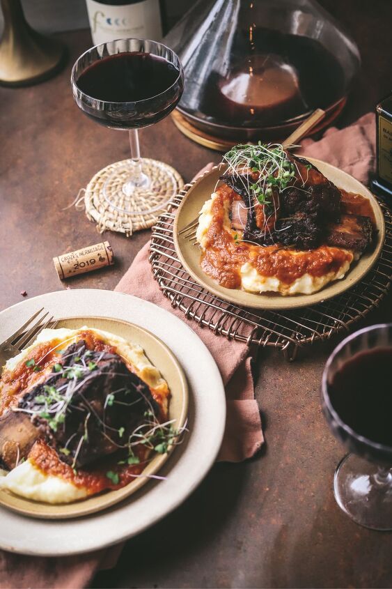 braised beef short ribs, Beef short ribs surrounded by red wine and wine glasses