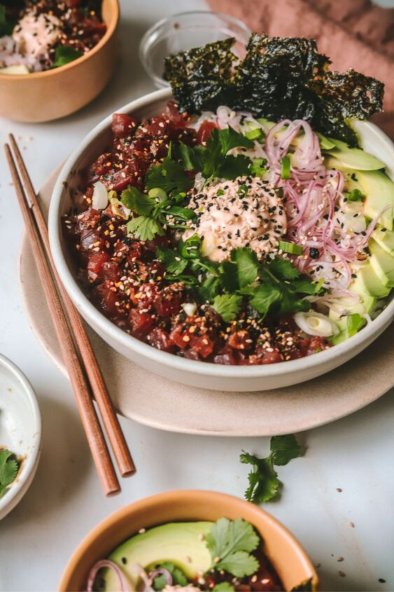 poke bowl with spicy mayo, A Pok bowl on a plate served with avocado and cilantro with spicy mayo