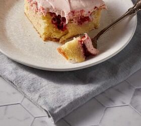 strawberry jam cake with cream cheese frosting, A fork with a bite of strawberry jam cake on a plate on a grey napkin