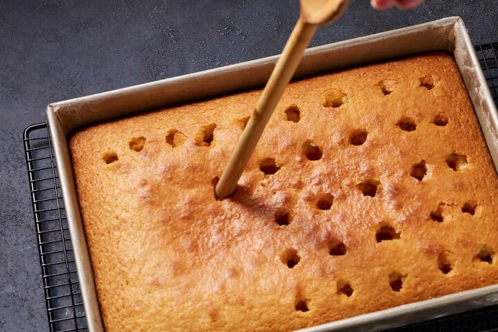 strawberry jam cake with cream cheese frosting, Use the base of a wooden spoon to poke holes in the cake