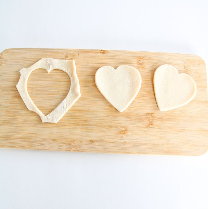 easy raspberry hand pie recipe, the dough being cut into heart shapes