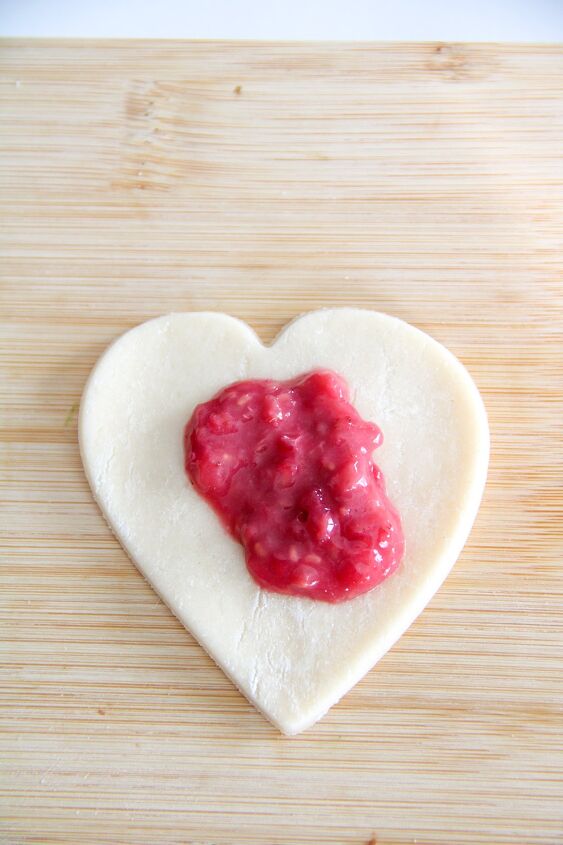 easy raspberry hand pie recipe, heart shaped dough with raspberry filling on top