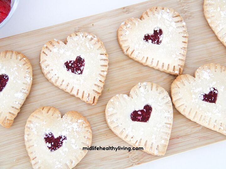 easy raspberry hand pie recipe, a close up of raspberry hand pies on a cutting board