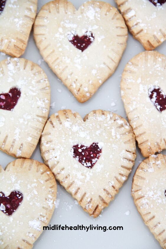easy raspberry hand pie recipe, a close up of the heart shaped raspberry hand pies
