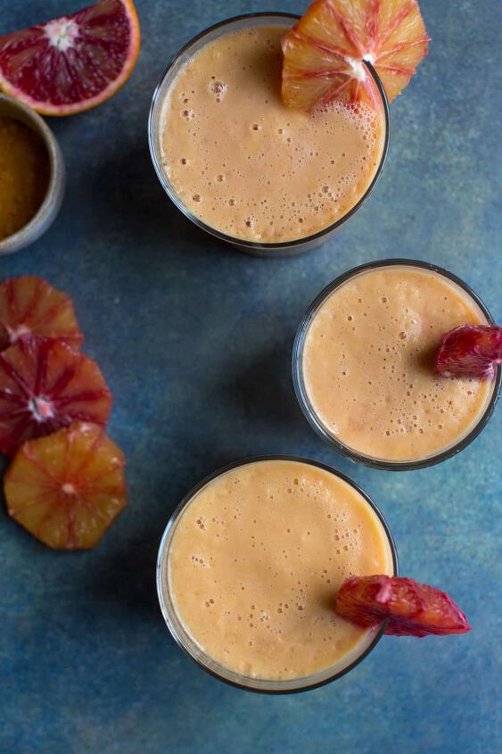 blood orange mango and turmeric smoothie, blood orange and turmeric smoothie in three glasses