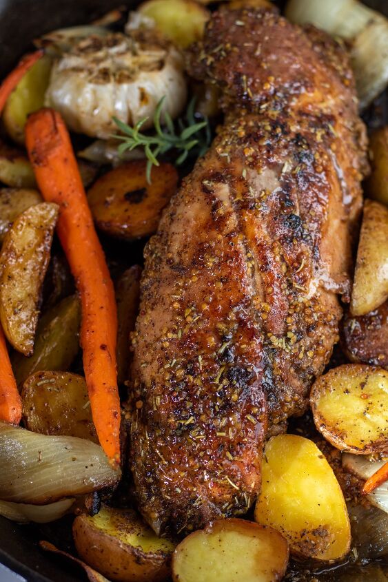 honey mustard roasted pork tenderloin with potatoes and carrots, A whole oven roasted pork tenderloin that s been cooked in the oven It s golden brown with a honey mustard glaze on top There s roasted potatoes carrots and onions around it