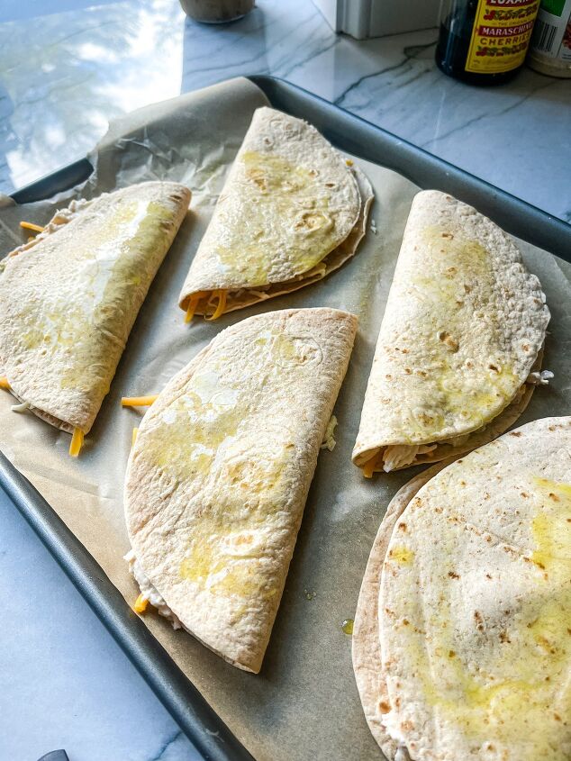 sheet pan chicken quesadillas, unbaked chicken quesadillas on a sheet pan