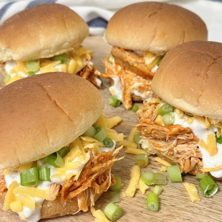 slow cooker buffalo chicken sliders, Slow Cooker Buffalo Chicken Sliders topped with ranch dressing cheddar cheese and sliced green onions