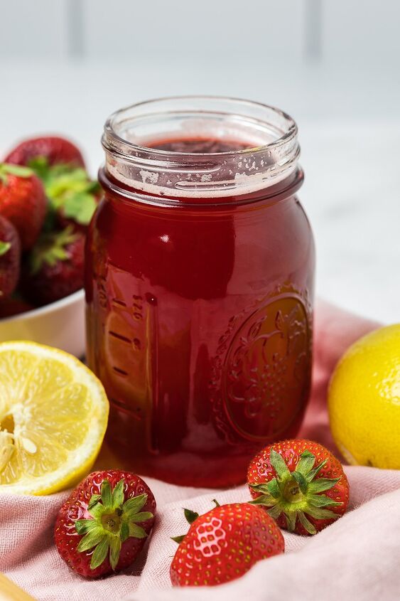 strawberry simple syrup, Strawberry Simple Syrup in a canning jar with fresh fruit around it