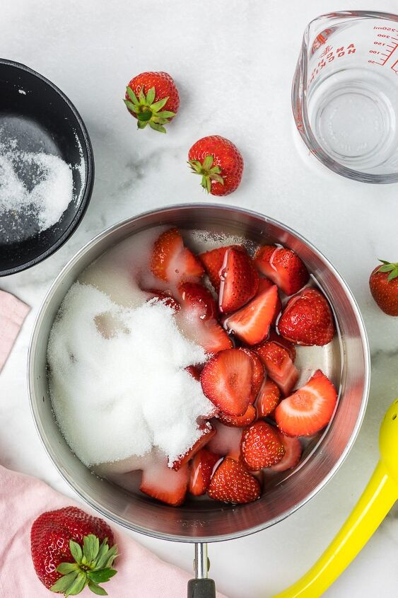 strawberry simple syrup, Sliced strawberries with water and sugar in a sauce pan