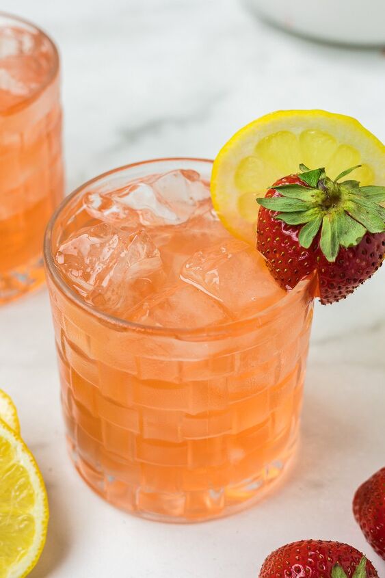 strawberry simple syrup, Strawberry simple syrup with lemonade in a glass cup with a strawberry as garnish