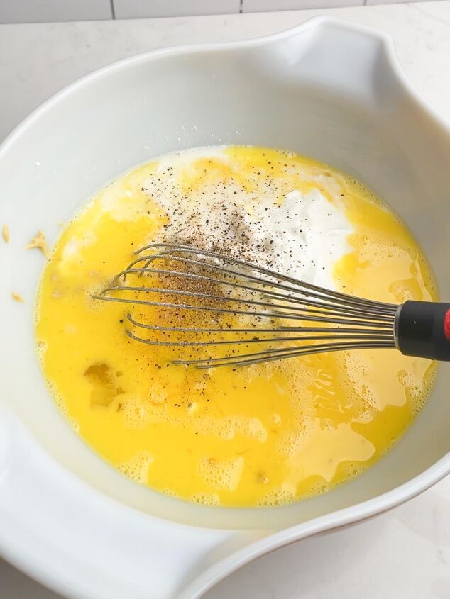 easy cheesy sausage egg bake, eggs mixture in white bowl