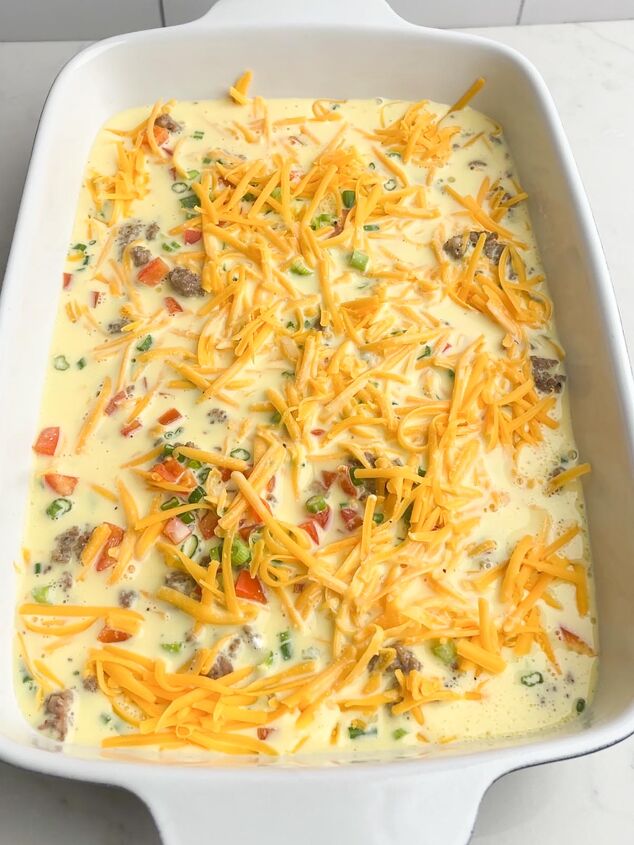 easy cheesy sausage egg bake, unbaked egg casserole with white casserole dish