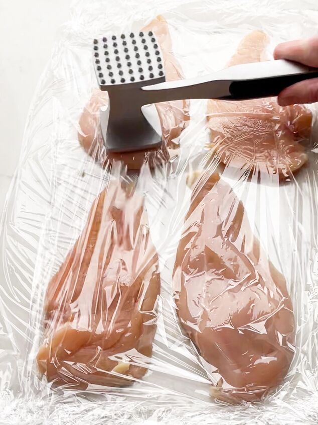 crispy baked thin chicken breasts, meat mallet pounding thin sliced chicken between layers of plastic wrap