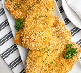 crispy baked thin chicken breasts, baked thin sliced chicken with panko on white platter on black and white napkin