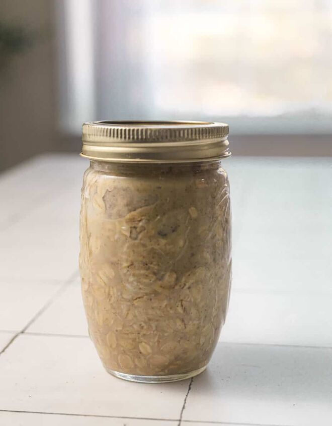 quick simple protein overnight oats, All ingredients for protein overnight oats layered in a mason jar after mixing