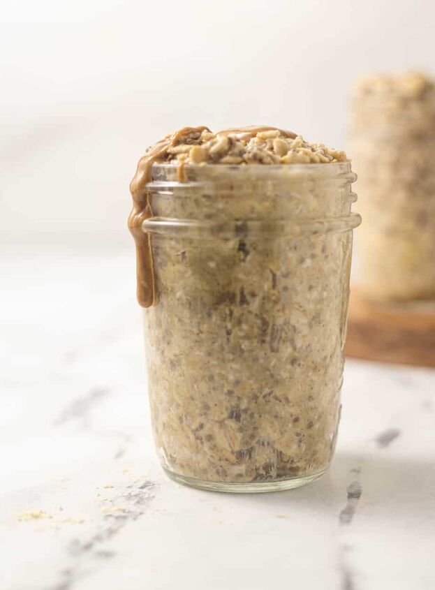 quick simple protein overnight oats, Protien overnight oats in a mason jar with peanut butter dripping off side