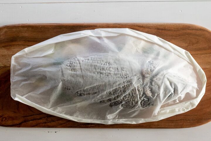 whole fish en papillote, Fish fully wrapped in parchment paper ready for baking