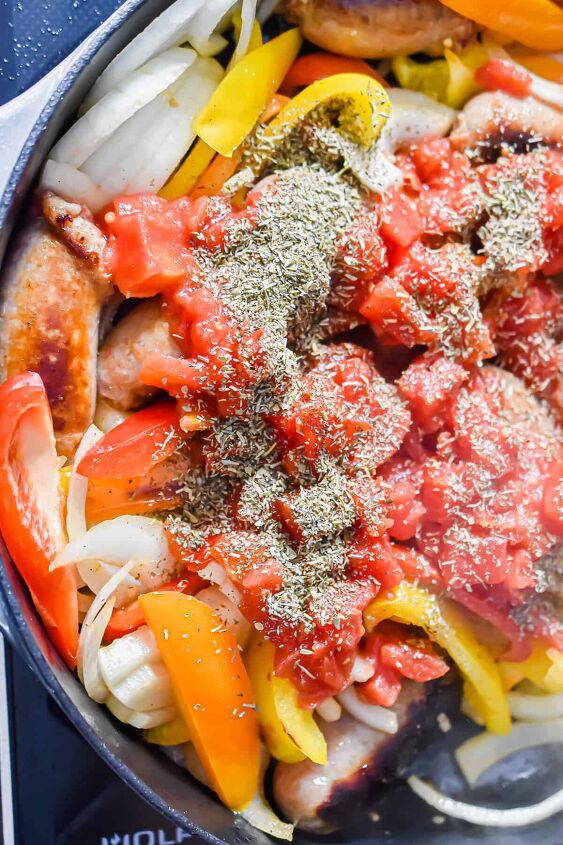 one pot sausage and peppers, The tomatoes and Italian seasoning are added to the pot