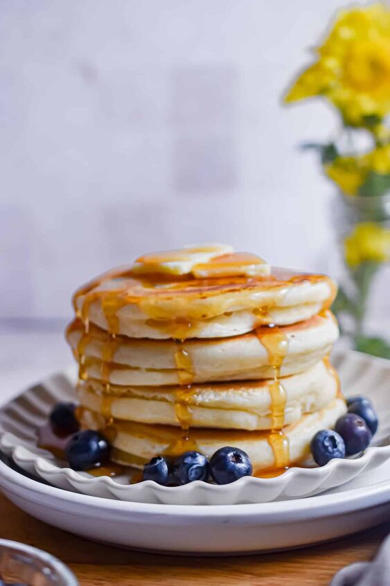 fluffy pancakes with cake flour, A stack of pancakes with cake flour are on a plate with maple syrup dripping down