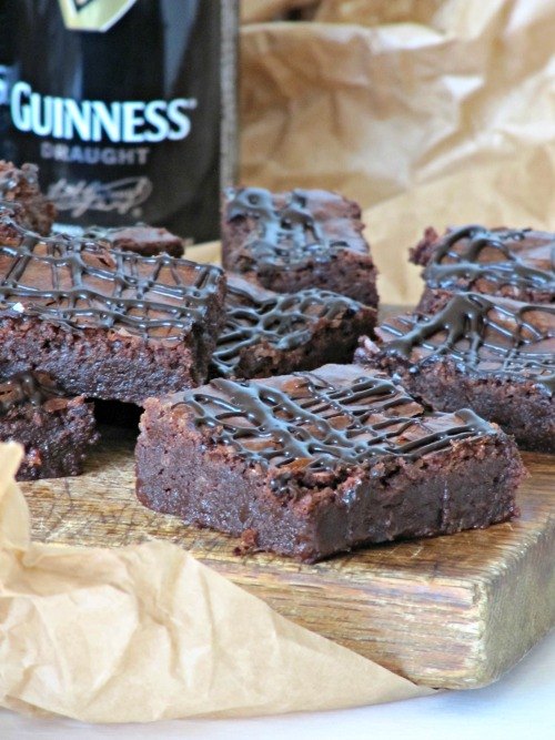 fudgy caramel stuffed brownies with sea salt, guinness chocolate stout brownies with a Guinness bottle in the backround