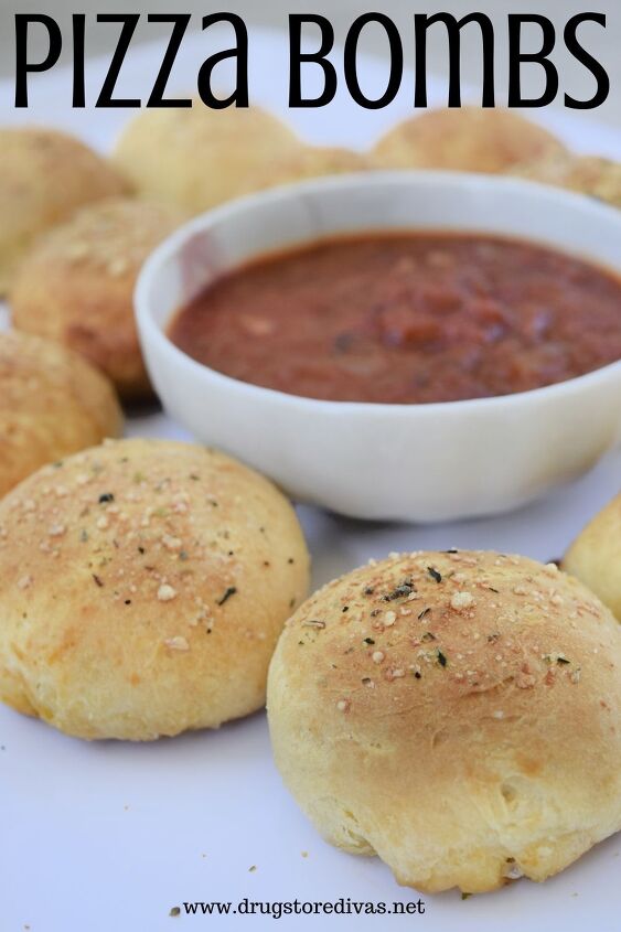 Ten rolls surrounding marinara sauce that s in a bowl with the words Pizza Bombs digitally written on top