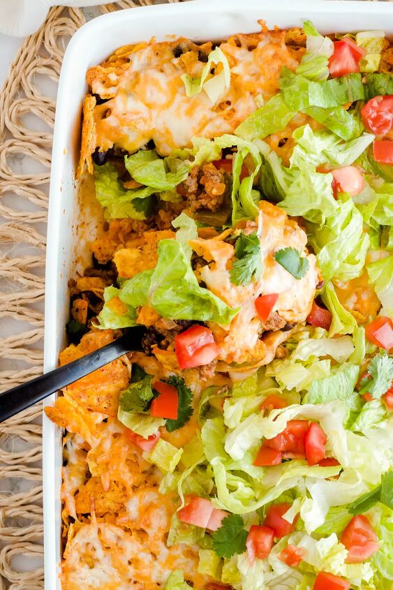 walking taco casserole with doritos, Overhead shot of a black spoon taking out a scoop of casserole