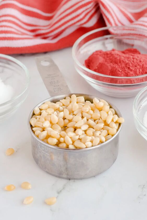sweet salty strawberry popcorn, Popcorn kernels in metal measuring cup surrounded by other ingredients