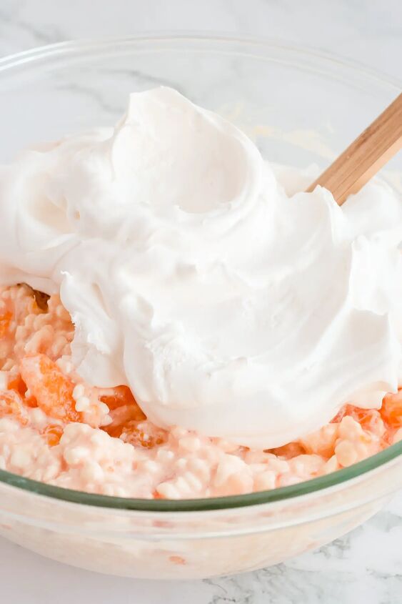 orange jello salad with cottage cheese, Whipped topping on top of salad ready to fold in