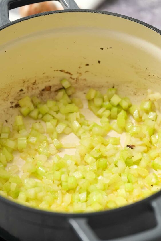 hearty vegan cream of mushroom soup with coconut milk, Saut ing onion and celery in a large cooking pot