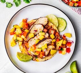 blackened chicken tacos with mango salsa, One blackened chicken taco on a white plate with refried beans and mango salsa