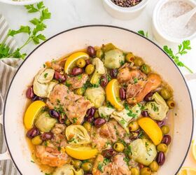 easy greek chicken thighs, Greek chicken thighs in a pan with olives lemons and artichoke hearts