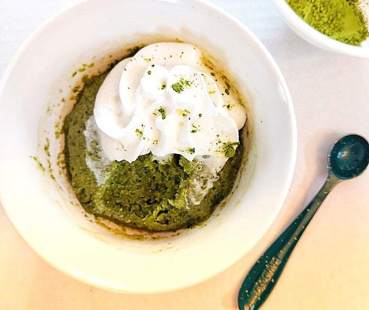 2 minute easy matcha mug cake that matcha latte lovers need in their l, Matcha mug cake with whipped cream and a spoon on the side