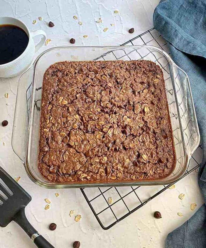 chocolate baked oatmeal happy honey kitchen, Chocolate baked oatmeal in a glass baking dish sitting on a cooling rack A black spatula and cup of coffee are next to the dish