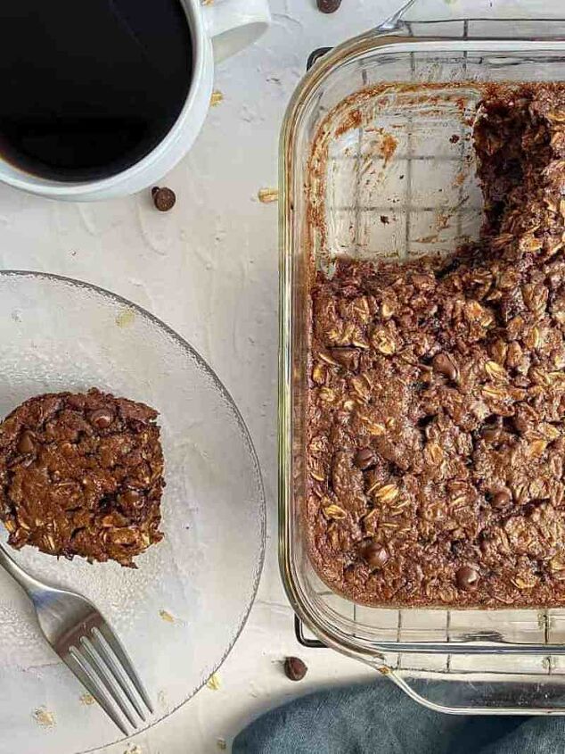 chocolate baked oatmeal happy honey kitchen, A cup of coffee is on a table with the baked oatmeal and a serving of baked oats on a plate with a fork