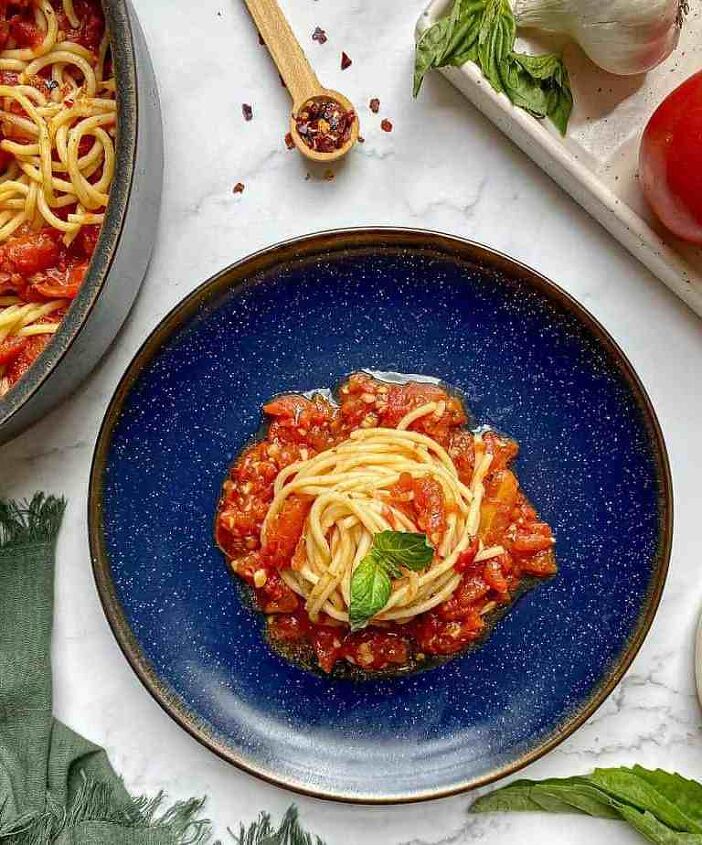 spaghetti arrabiata happy honey kitchen, Spaghetti in a spicy red tomato sauce is on a blue plate A skillet with pasta arrabiata fresh basil and a green kitchen towel are surrounding the plate