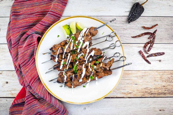 grilled steak skewers with mojo rojo, A top down image of grilled steak skewers on a plate