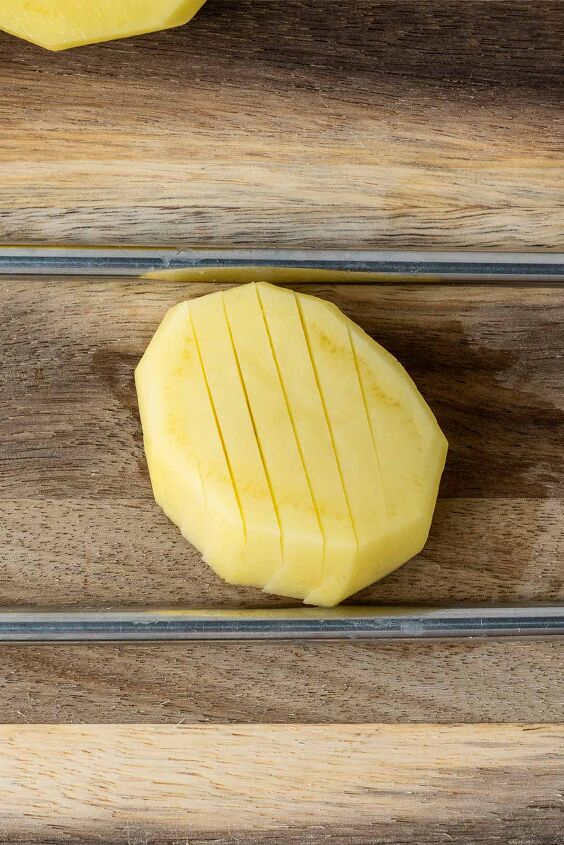 air fryer accordion potatoes, Flip the potato and cut the other side diagonally letting the chopstick stop the knife from going all the way through the potato