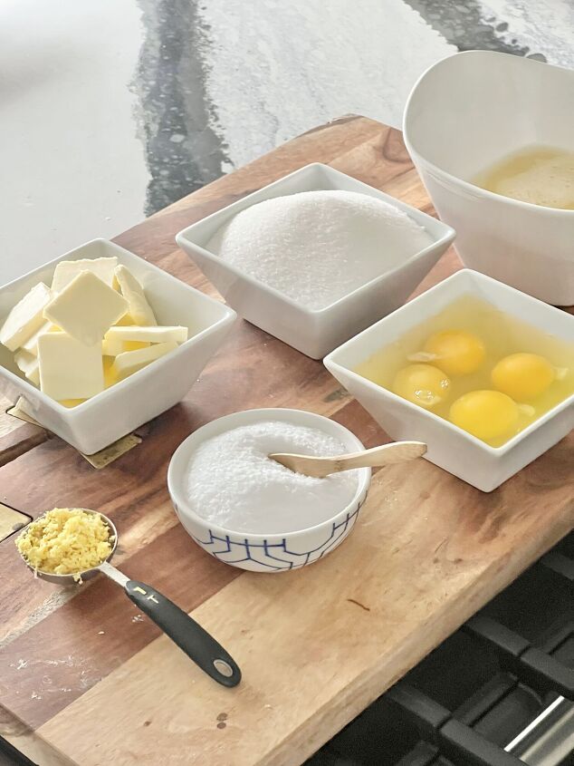 how to make lemon curd, Ingredients for lemon curd displayed on a wood cutting board