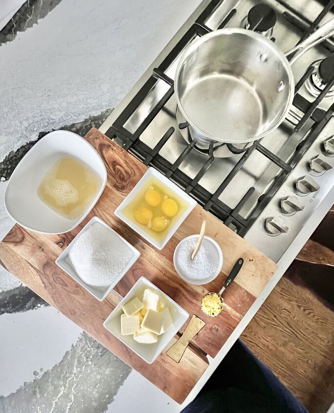 how to make lemon curd, A pan on the stove beside bowls of lemon juice sugar eggs butter salt and lemon zest