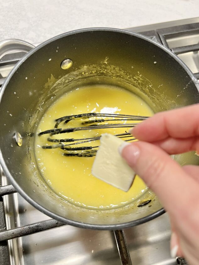 how to make lemon curd, Ingredients combined into a saucepan on the stove and adding pats of butter