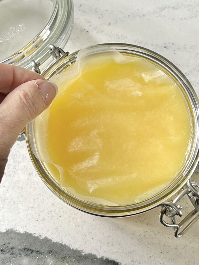 how to make lemon curd, A piece of wax paper laid on top of a jar of lemon curd to prevent a skin from forming