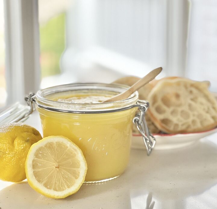 how to make lemon curd, A wooden spoon dipped into a jar of fresh homemade lemon curd