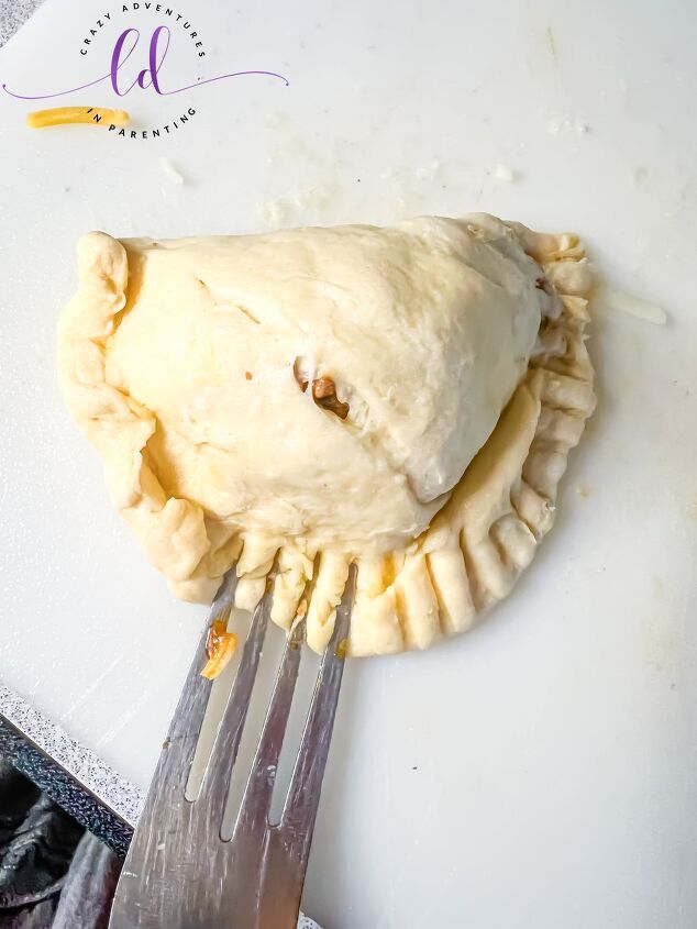 easy air fryer beef empanadas recipe, Seal the edge of the crescent roll dough with a fork to make Easy Beef Empanadas