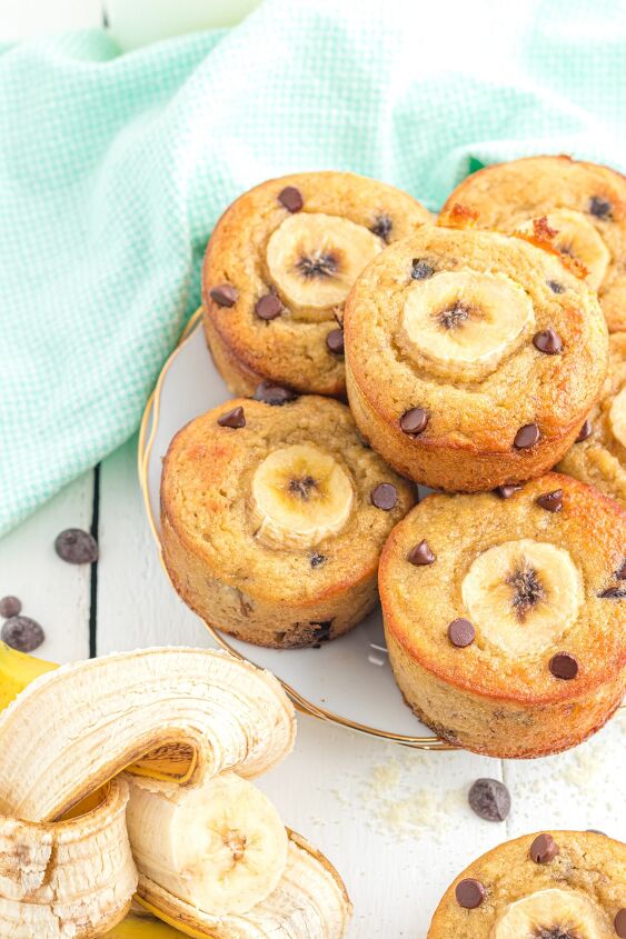 banana muffins with almond flour, Banana muffins on a plate on a table with a banana and chocolate chips